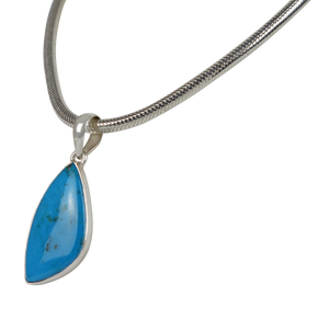A simple Uncustomary Shape Blue Turquoise Set on Sterling Silver Open Back bazel