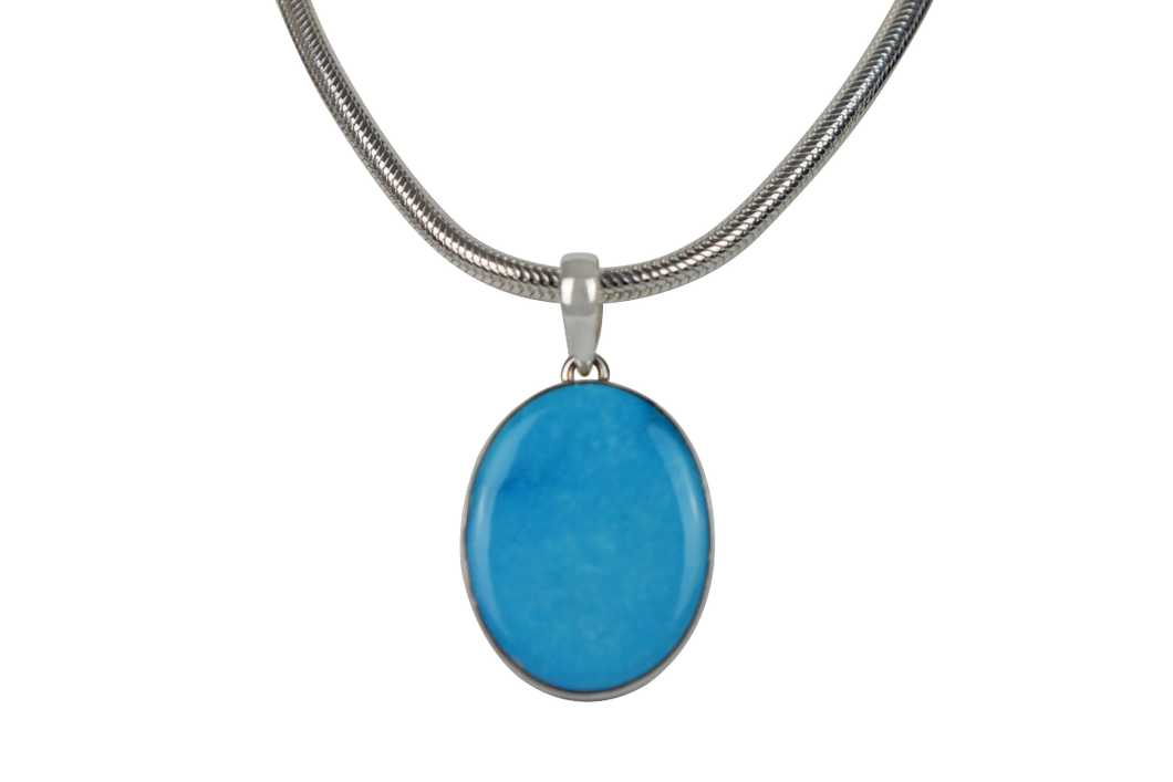 A classic Circle to Oval Shaped Blue Turquoise Set on Sterling Silver Open Back bazel