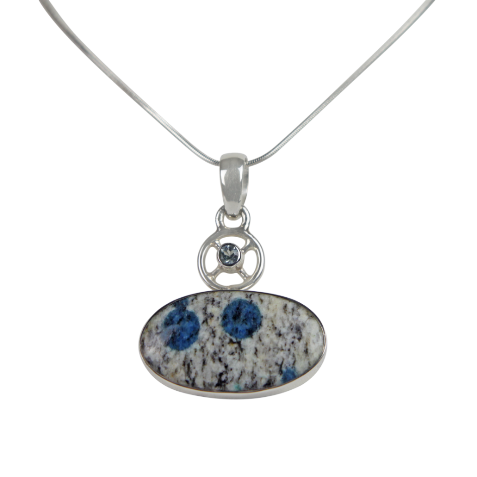 A charming Oval Shaped K2 Jasper Pendant Accent with a Tiny Blue Topaz on a Wagon Wheel