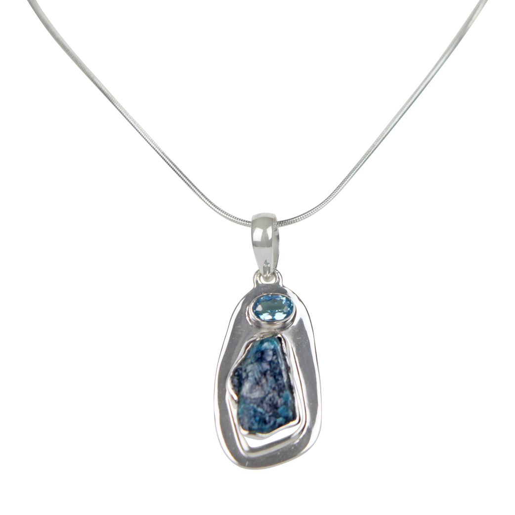 A beautiful rough Neon Apatite pendant accent with a Blue Topaz and elegantly hand set in Sterling Silver bazel.