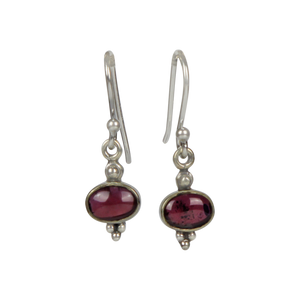 Minimalistic garnet drop earrings set into sterling silver in a classic ethnic style