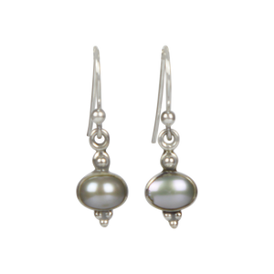 Minimalistic pearl drop earrings set into sterling silver in a classic ethnic style