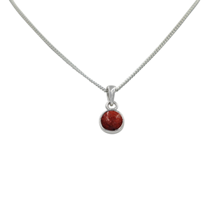 A simple round Coral pendant presented on a sterling Silver chain