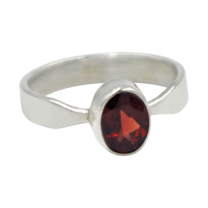 A very delicate ring in sterling silver with a small faceted oval Garnet stone.